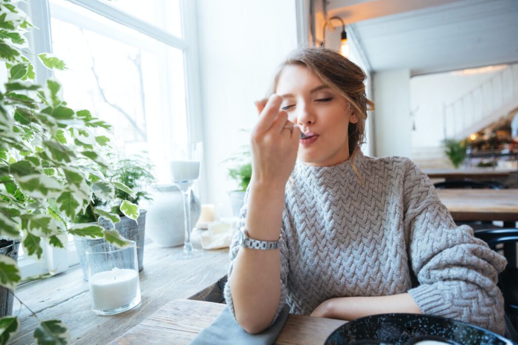 Woman eating in restaurant